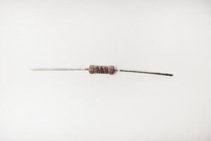 A brown resistor on a white background. The electronic component. photo