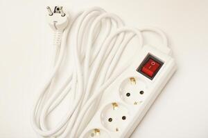 A triplex outlet cord with a white cable set against a blank white background. photo