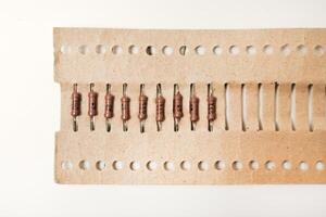 The electronic component. Brown resistor in a paper package. photo