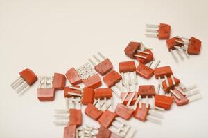 Ancient transistors on a white surface. Electrical components. photo
