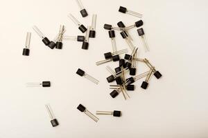 Dated transistors on a white base. Microchip elements. photo