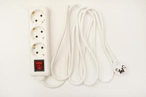A triple-receptacle extension wire in white, positioned on a pristine white surface. photo
