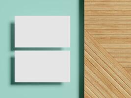 A top-down view of a clean business card mockup on a wooden surface, casting sharp shadows, with a pastel blue backdrop enhancing the minimalist vibe. photo