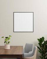 A black square photo frame on a light wall, with plants and a wooden table, ideal for showcasing smaller artwork or photographs in a modern setting.