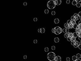 Multiple soap bubbles floating on a dark backdrop. photo