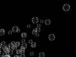 Bubbles floating in the air with a dark background. photo