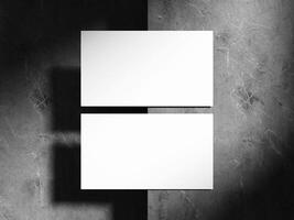 A high-angle shot of a minimalistic business card with soft shadows on a dark marble background, perfect for showcasing contemporary design elements. photo