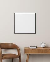 A sleek black square photo frame placed above a desk with a brown chair, books, and clock, great for showcasing creative designs.