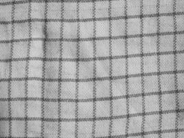 Close-up of a grid-patterned fabric in gray tones, showcasing a structured design. photo