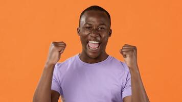 Man express excitement and victory through gestures and smiles. Hisemotions reflect a moment of happiness and achievement video