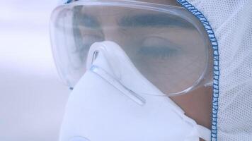 A young Middle Eastern woman dressed in protective gear stands outdoors, focused and attentive. She embodies a vigilant approach towards health and safety in a bustling urban environment. video