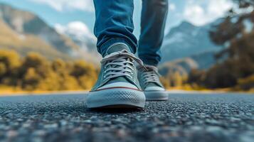 A person walking on a road with sneakers photo