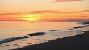 Relaxing sunset view over calm ocean waves at the beach in summer video