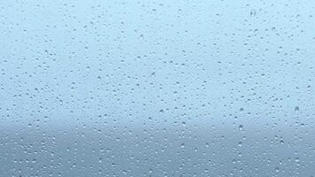 Raindrops gather on a window, creating a tranquil ambiance during a gloomy afternoon in the city video