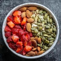 Freshly Mixed Bowl with Almonds, Strawberries, Seeds, and Nuts photo