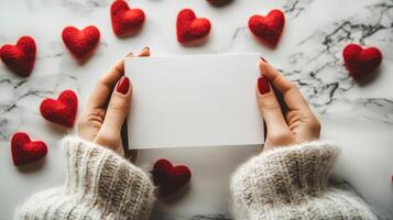 Realistic photo of hands holding blank card with red hearts