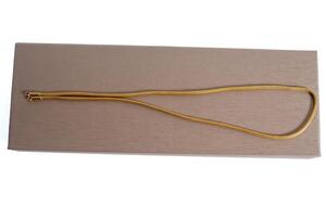 Gold chain on top of brown cardboard box on white background photo