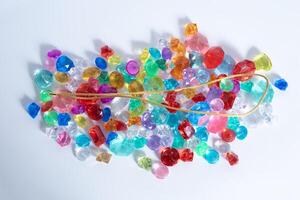 gold chain over various colorful decorative gems. photo