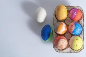 Colorful easter eggs in a cardboard box photo
