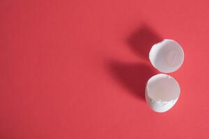 Two white eggs on a red background photo