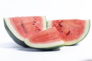 Freshly cut juicy watermelon slices with vibrant red flesh on a white background photo