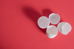 Three white eggs on a red background photo