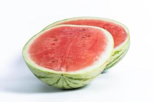Fresh watermelon cut in half with bright red flesh on a white background photo