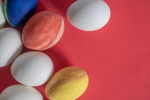 Colorful easter eggs on red background photo