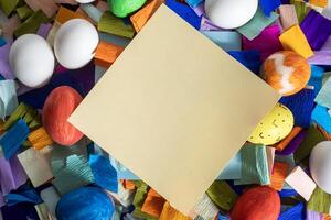 A piece of paper is surrounded by colorful eggs photo
