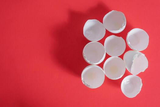 Broken egg shells on a red background photo