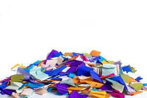 Pile of brightly colored craft paper pieces on a white background photo