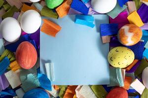 Colorful easter eggs and paper with blank space photo