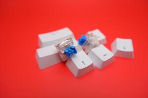 Clicky Blue Switch and Keycaps for Mechanical Keyboard on Red Background photo