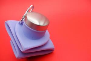 Purple Foldable Bottle Isolated on Red Background photo