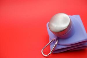 Foldable Water Bottle in Vibrant Purple on Red Surface photo