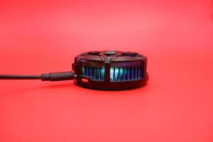 Wired Mobile Cooler Against Red Backdrop photo