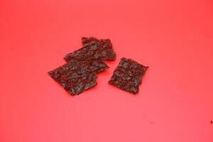 Dried Nori on a Red Surface, A Natural Source of Minerals and Fiber photo