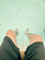 Relaxing by the Poolside with Legs Submerged photo