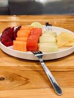 Assorted Fresh Fruit Slices on Plate photo