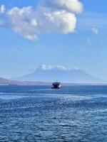 Ferry Boat on a Calm Sea with Distant Mountains photo