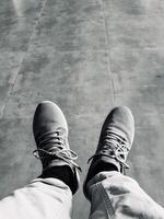 Monochrome View of Sneakers on Tiled Floor photo