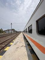 Train Parked at Empty Railway Station Platform photo