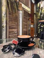 Coffee with Foam Art in Rustic Outdoor Cafe photo
