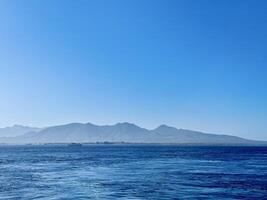 Scenic View of Bali Strait with Deep Blue Ocean and Clear Sky Overlooking the Island of Bali. Serene Seascape, Natural Horizon, Tropical Destination, Travel, Coastal Photography photo