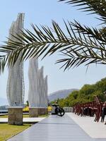 Scenic Walkway with Sculptures and Palm Trees. Capture from Utama Raya Situbondo photo