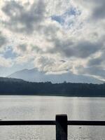 Scenic Lake and Mountain View with Dramatic Clouds. Lemongan Mountain Lumajang, Indonesia photo
