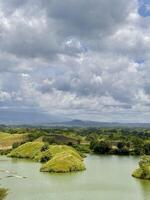 Scenic Lake with Green Islands and Cloudy Sky. Bajulmati Dam Situbondo photo