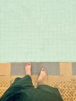 Bare Feet at the Edge of a Swimming Pool photo