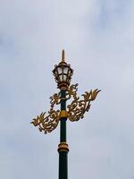 Ornate Street Lamp Against Cloudy Sky photo