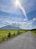 Volcano and Cloud Trail with Path in Foreground. Baluran National Park Situbondo. photo